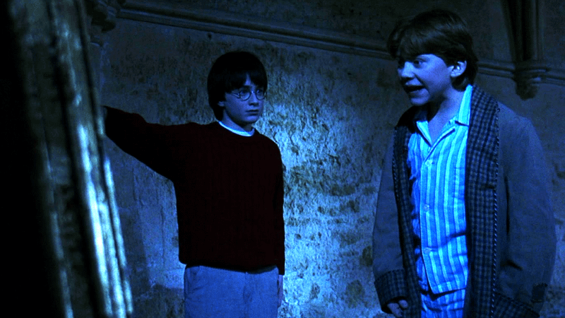 Daniel Radcliffe as Harry Potter and Rupert Grint as Ron Weasley looking at the Mirror of Erised in 'Harry Potter and the Sorcerer's Stone.'