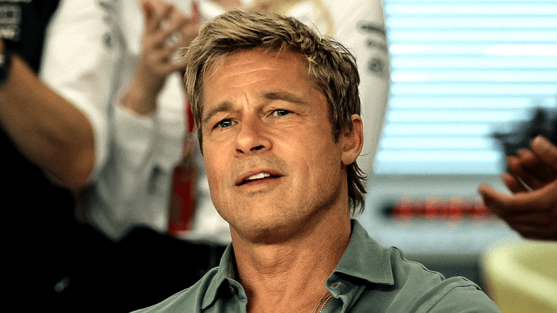 Brad Pitt as Sonny Hayes in F1 wearing a green collared zip-up