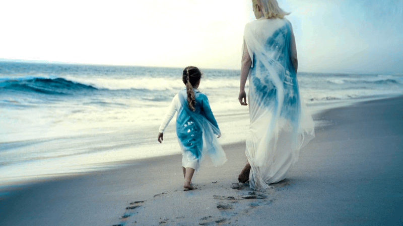 small girl next to Shalla-Bal on a beach in The Fantastic Four: First Steps