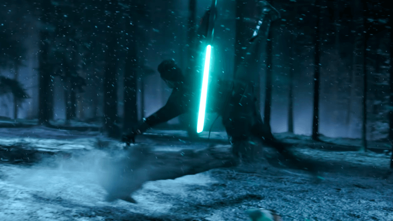 A mysterious character wielding a cyan lightsaber and jumping in the air in Ahsoka.