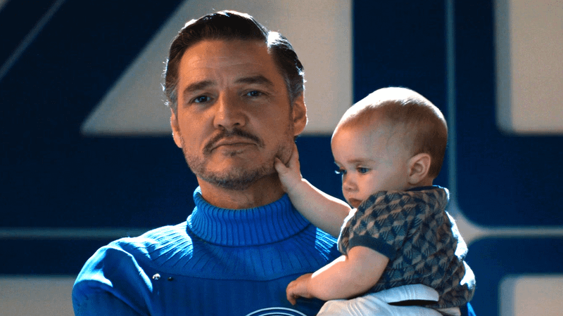 Pedro Pascal as Reed Richards holding a baby Franklin Richards in Fantastic Four: First Steps