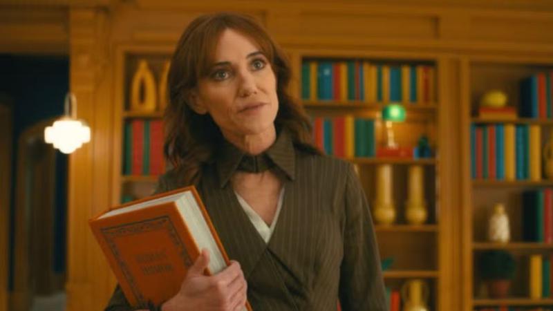 FRIDAY holding a book in VisionQuest.