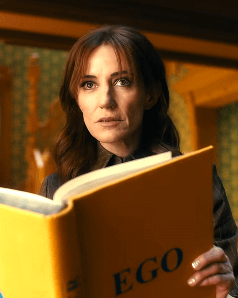 Orla Brady as FRIDAY reading Ego book in VisionQuest.
