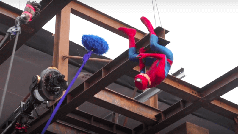 Tom Holland as Spider-Man sitting upside down on beam in 'Spider-Man: Brand New Day.'
