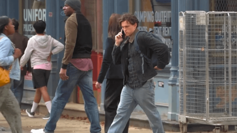 Tom Holland walking down the street as Peter Parker in 'Spider-Man: Brand New Day.'