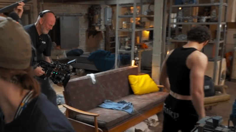 Tom Holland filming new material for 'Spider-Man: Brand New Day in front of a couch.