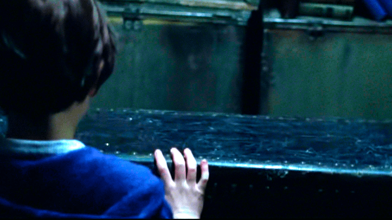 A young boy opening a box in Prodigal Son