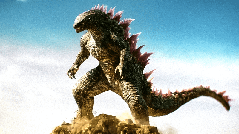 Godzilla standing with pink scales on back.