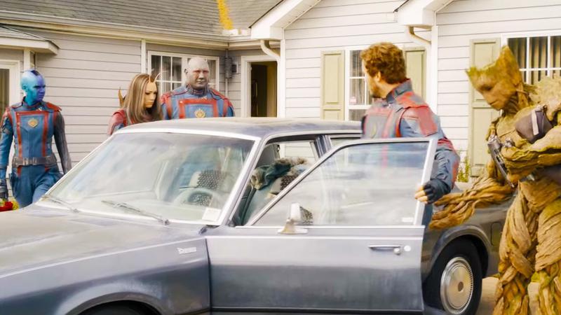 A photo of a clip from Guardians of the Galaxy Volume 3 showing the team trying to get in a small car.