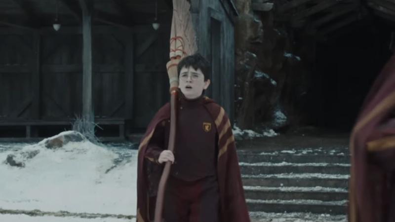 Harry Potter holding a broom in the HBO show.