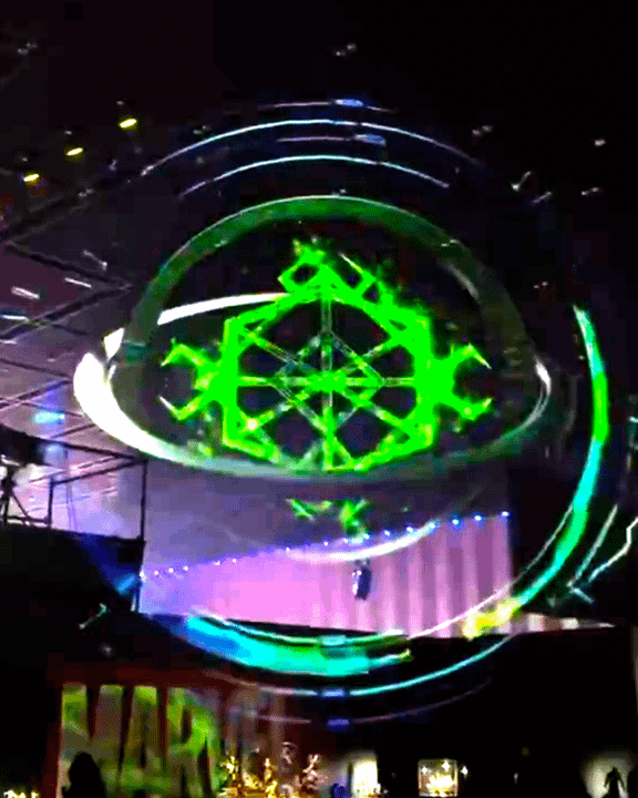 A green magic light show on a convention floor.