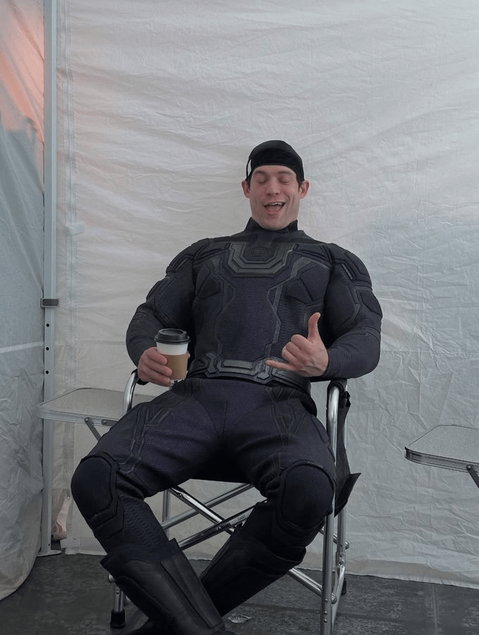 David Corenswet as Ultraman sitting in a chair on the Superman set