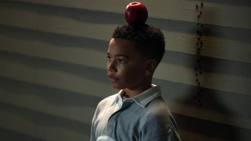 Young John Stewart with an apple on his head.