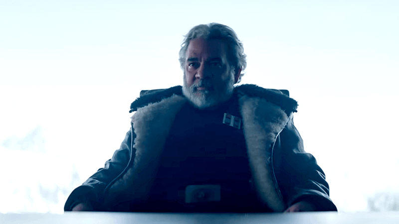 Hemky Madera’s imperial warlord sits at a table against a bright background in The Mandalorian Season 3.