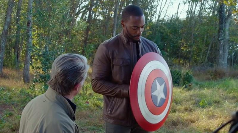 Sam Wilson holds the Captain America shield in Avengers: Endgame as Steve Rogers looks on.
