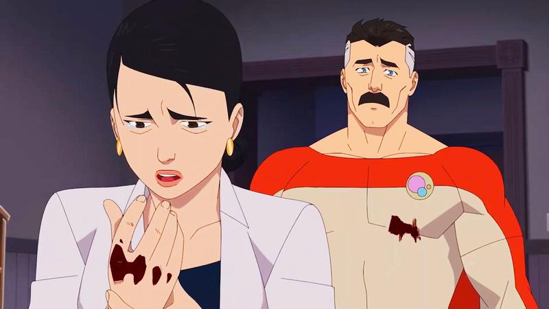Image from Invincible series showing Debbie cradling her broken hand while Nolan looks concerned.
