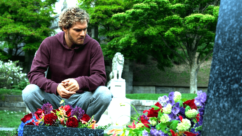 Finn Jones' Danny Rand sitting in front of his parents' grave in Iron Fist show
