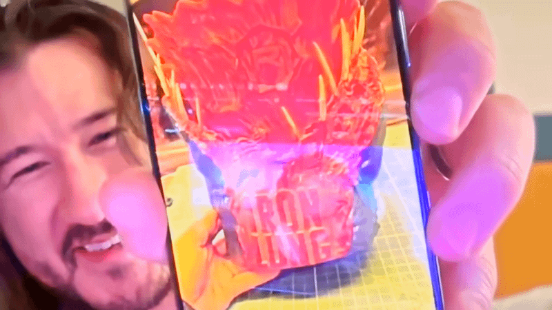 Markiplier showing off the Iron Lung popcorn bucket on a phone