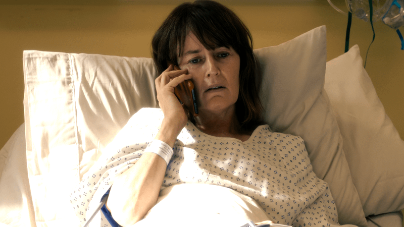 Rosemarie Dewitt as Jill Turner on her phone in a hospital bed in Untamed