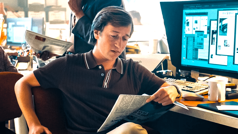 Jimmy Olsen reads a newspaper at the daily planet.