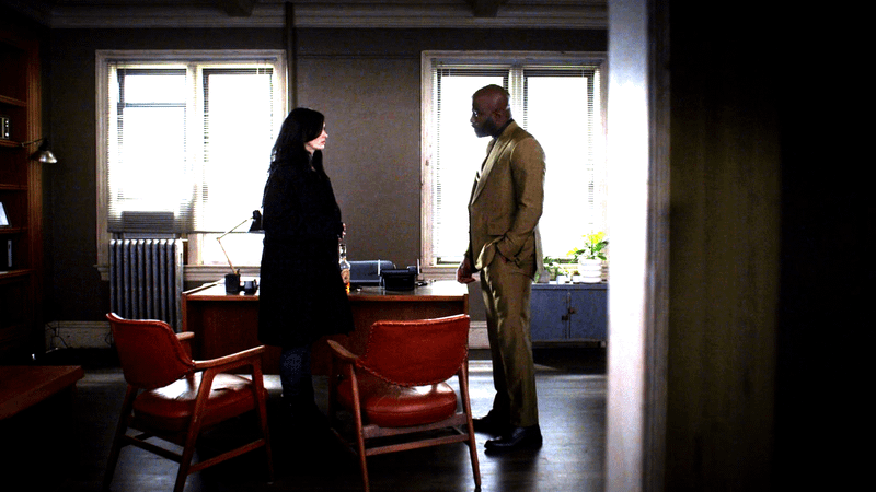 Krysten Ritter as Jessica Jones and Mike Colter as Luke Cage in Alias Investigations in 'Jessica Jones' Season 3.