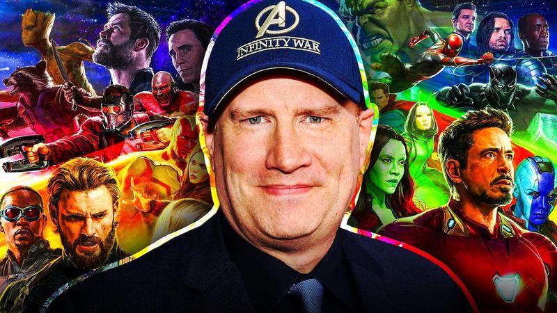 Kevin Feige with the Avenges behind him