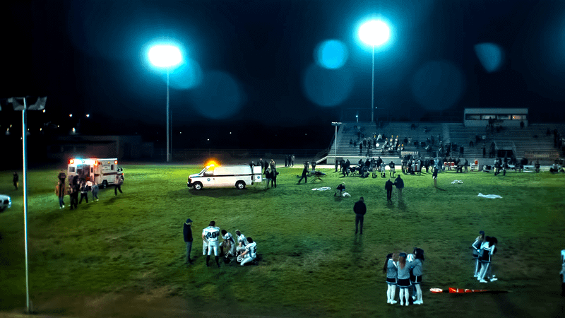 ambulances and football players on a football field in 'Lanterns' trailer.