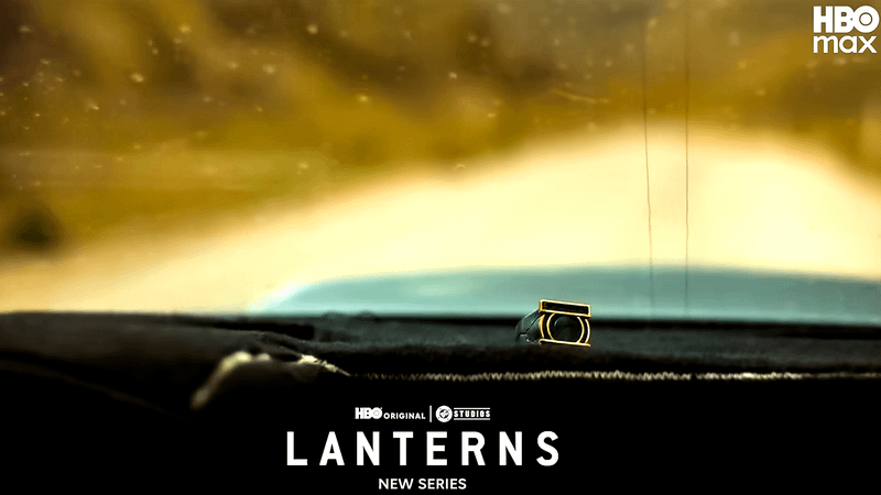 A close-up of a Green Lantern ring on a car dashboard in Lanterns.