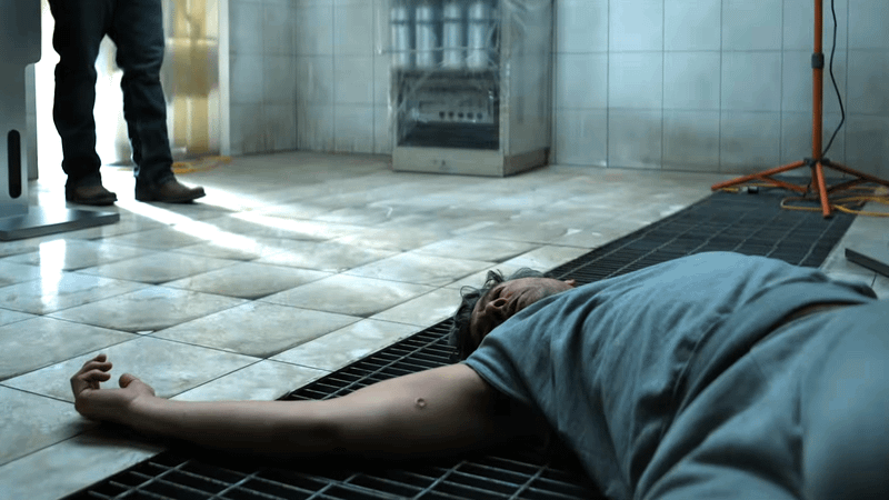 Hal Jordan on the ground with a circular mark on his arm.