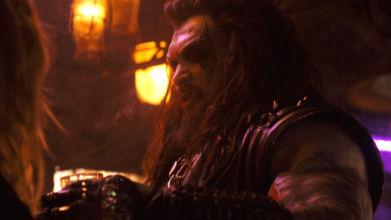 Jason Momoa as Lobo holding a drink in 'Supergirl.'