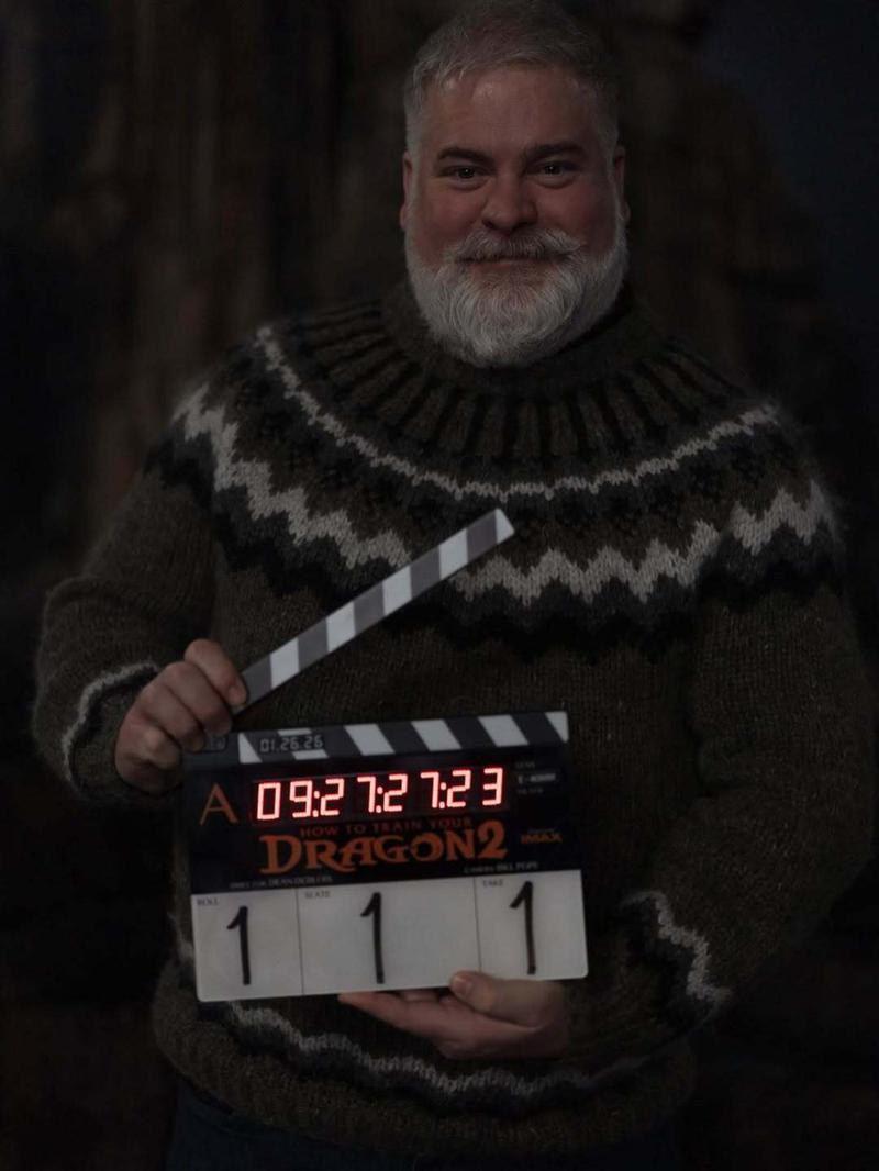 Dean DeBlois poses with How to Train Your Dragon 2 slate
