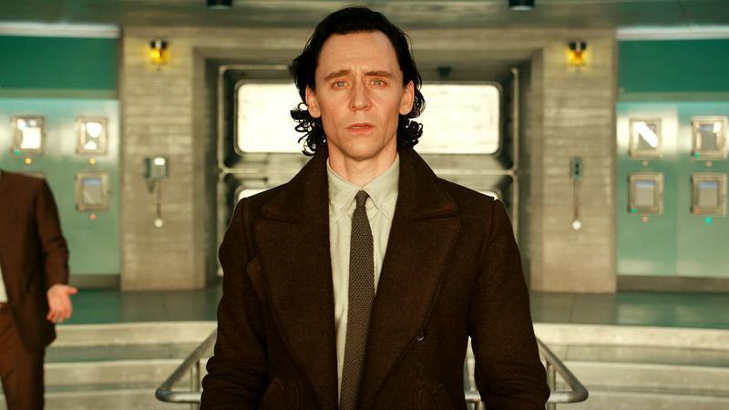 Tom Hiddleston as Loki looking at a bright light in Loki