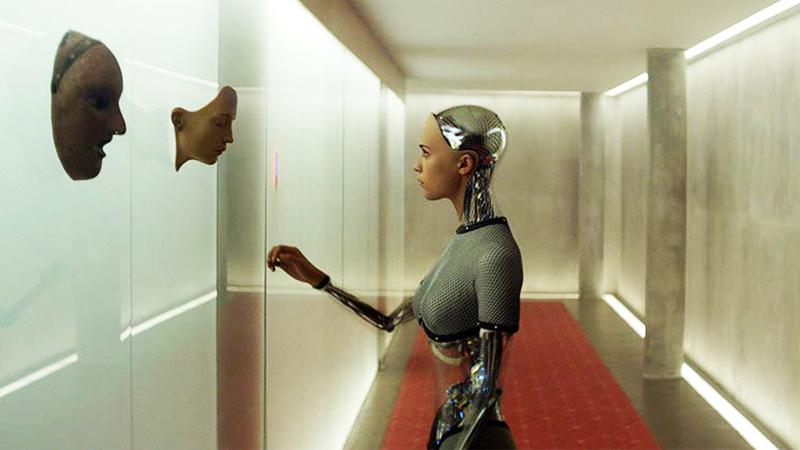 Alicia Vikander's Ava in Ex Machina looking at wall of android parts.
