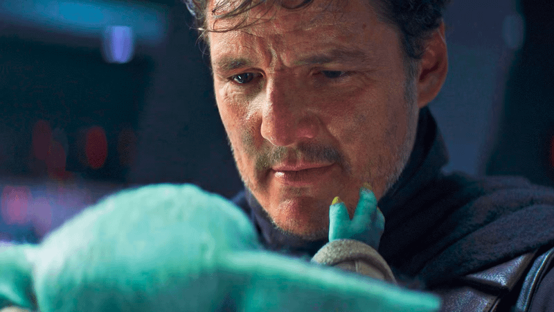 Pedro Pascal as Din Djarin with Grogu in The Mandalorian Season 2 Episode 8.