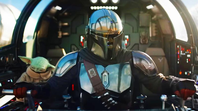 Din Djarin and Grogu in the Razor Crest in The Mandalorian & Grogu.