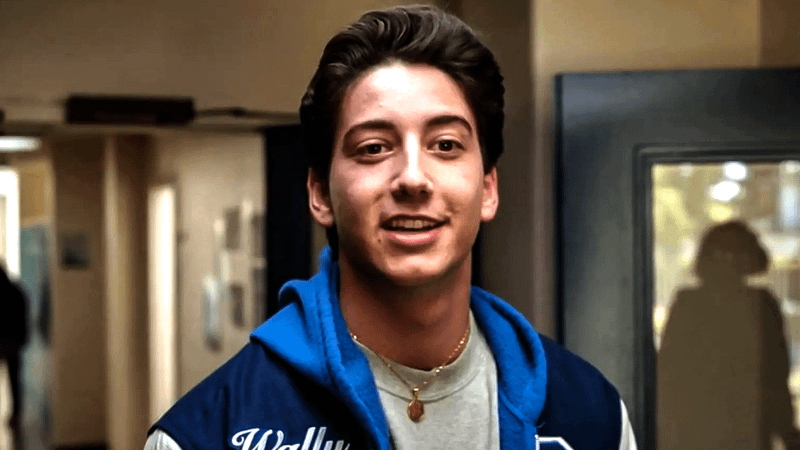 Milo Manheim as Wally in a letterman jacket in School Spirits.