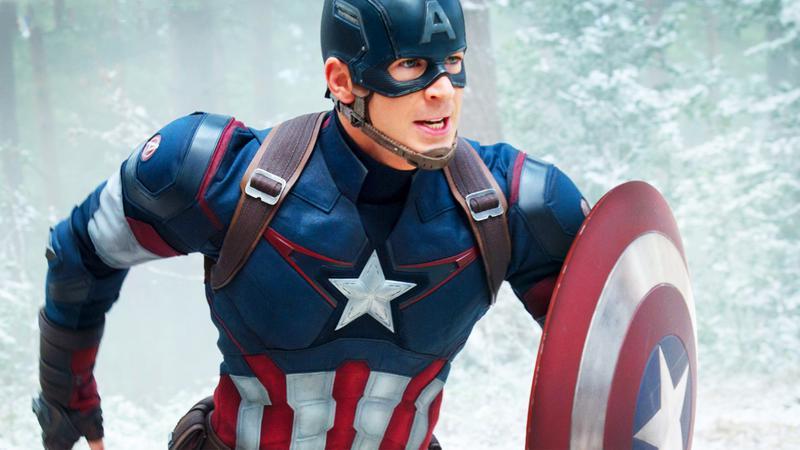 Chris Evans as Captain America in Avengers: Age of Ultron running through the snow with his shield out