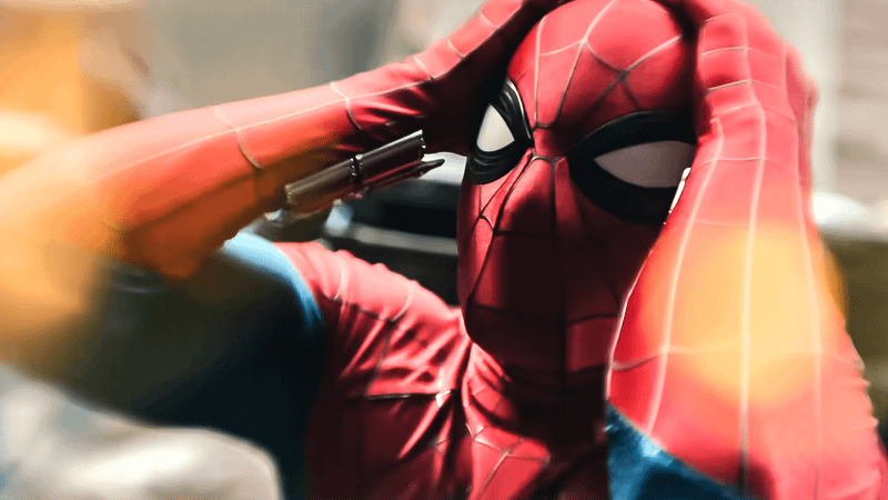 Spider-Man clearly in anguish holding his head.