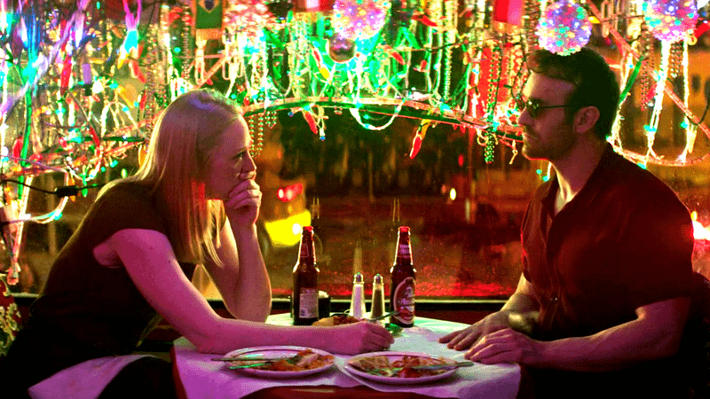 Deborah Ann Woll as Karen Page, Charlie Cox as Matt Murdock at dinner under the lights in 'Daredevil: Born Again' Season 2.