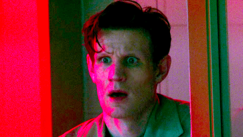 Matt Smith looking shocked soaked in a red light