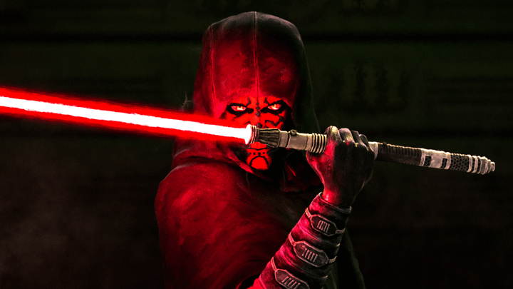 Maul with a hood on and holding a lightsaber in Shadow Lord.