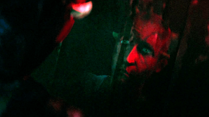 Maul looking at a younger version of himself in a reflection.