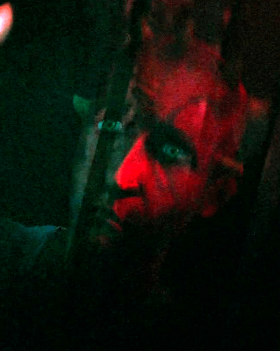 Maul looking at a younger version of himself in a reflection.