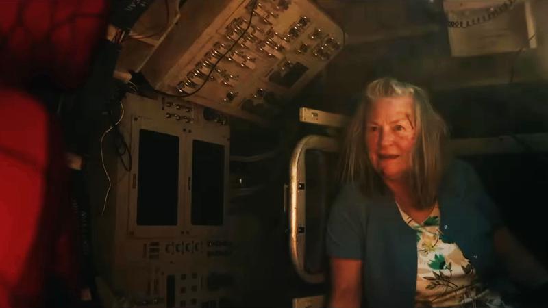 An older woman inside of the tank.