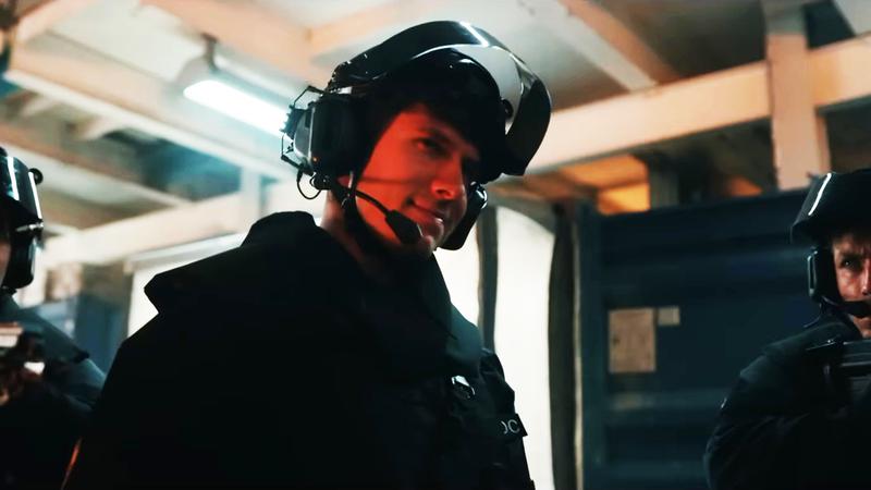 A DODC officer being taken over by mind control, smirking.