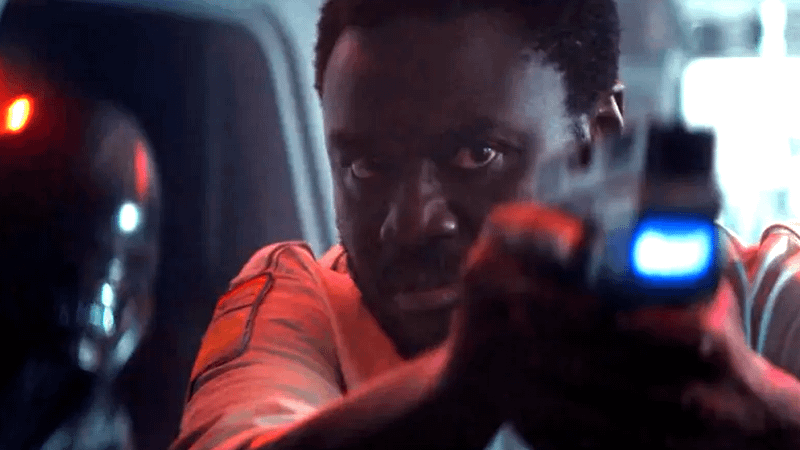 Morrow holding a gun with Xenomorph behind him in Alien: Earth