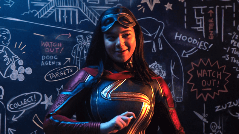Kamala Khan smiling in front of a board in Ms. Marvel.