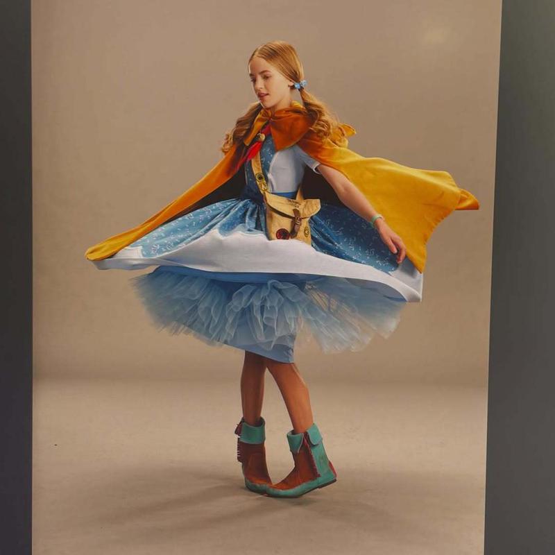 Nell Fisher as Holly Wheeler twirling in a dress in Stranger Things