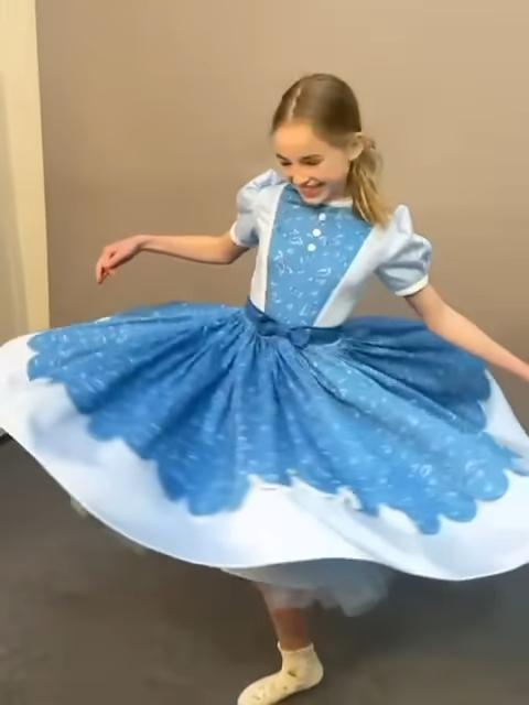 Nell Fisher twirling in a blue dress on the set of Stranger Things