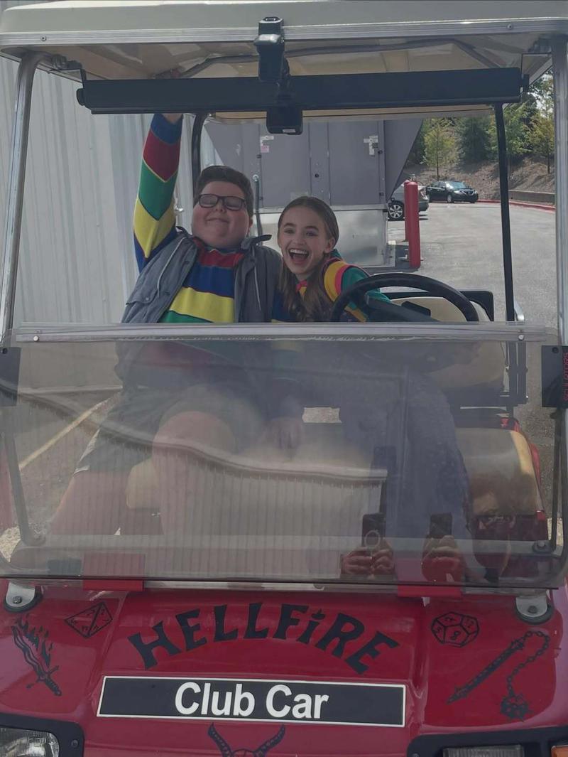 Nell Fisher and Jack Connelly in a golf cart on the set of Stranger Things
